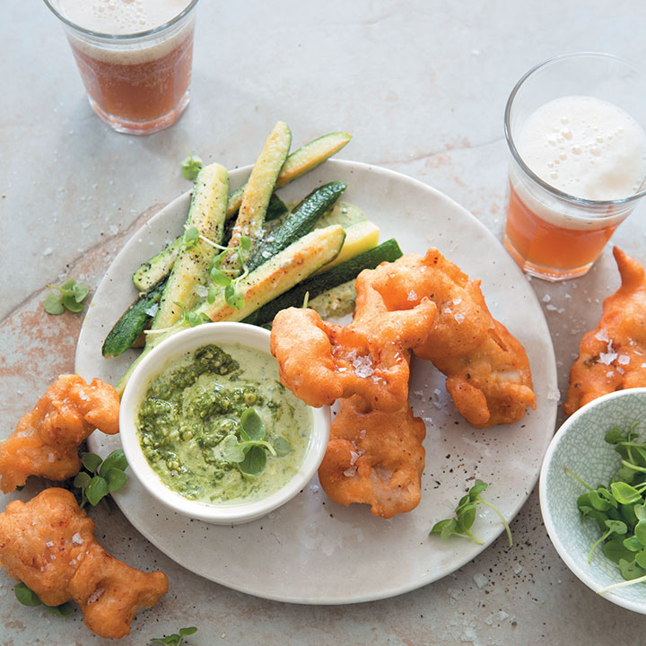 Beer-battered fish goujons with fried baby marrows and pesto sour-cream sauce