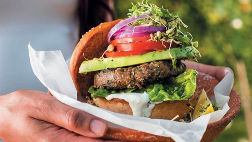 White bean and baby marrow burgers with cashew mayo and a sprout salad