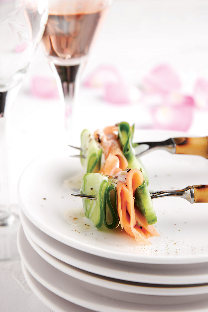Salmon and cucumber on forks served with crème fraîche and lemon drizzle recipe