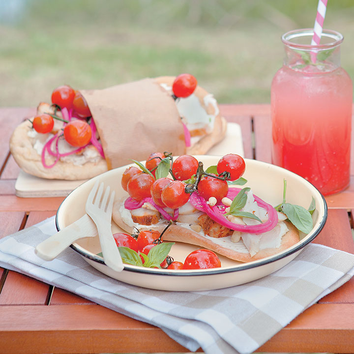 Flatbreads topped with roasted tomatoes, chicken and pickled red onions