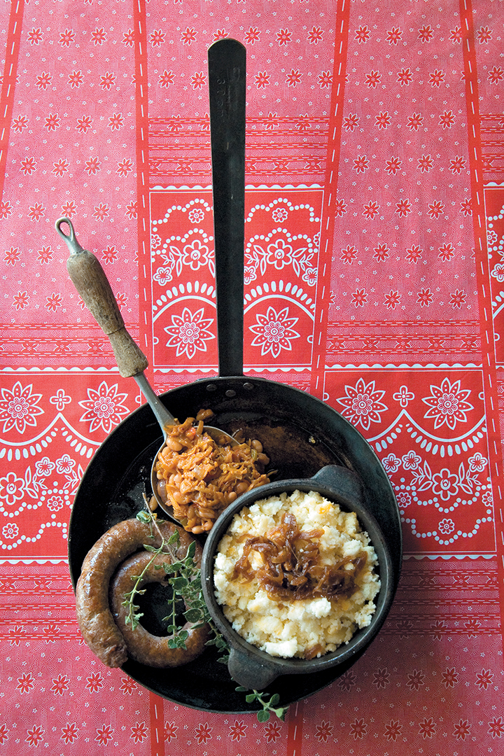 Three-cheese pap served with saffron chakalaka and classic boerewors