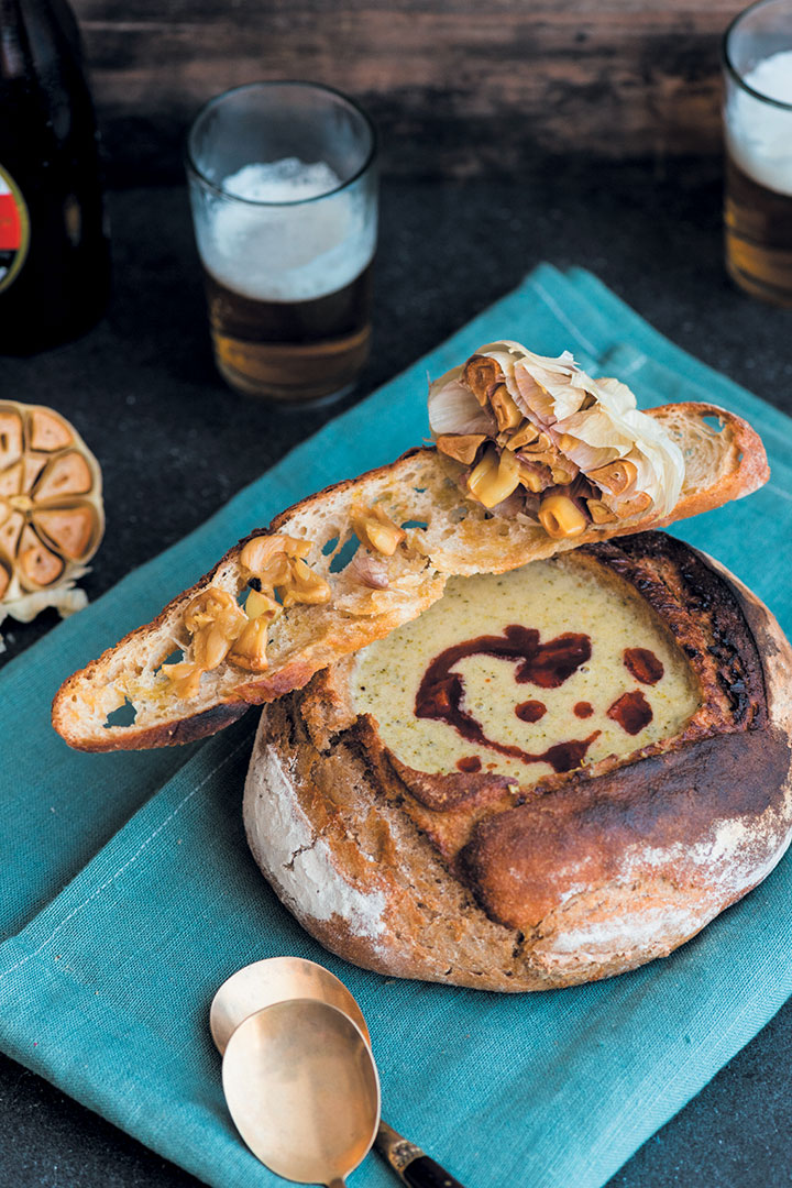 Beer, broccoli and Gruyère soup in bread bowls with chorizo oil and croutes with roasted garlic
