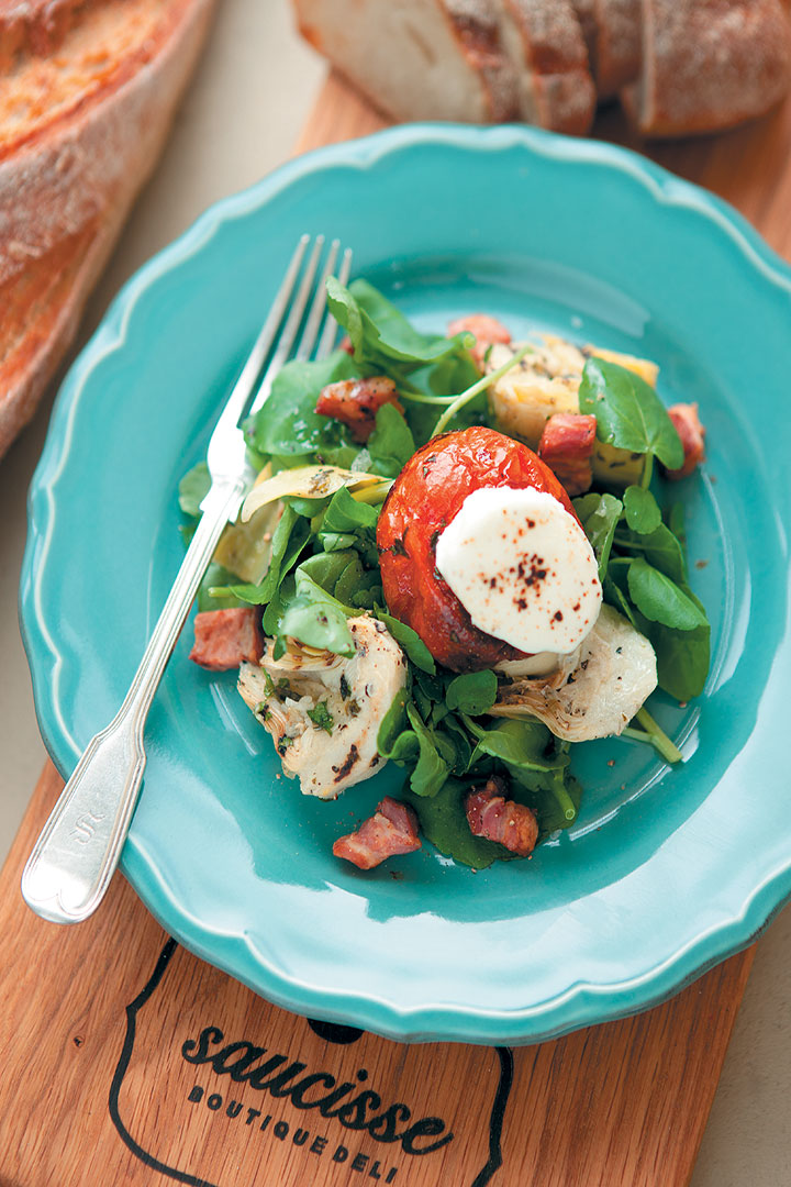 Slow roasted tomatoes topped with grilled goat’s cheese and crispy bacon lardons on a grilled artichoke and watercress salad recipe