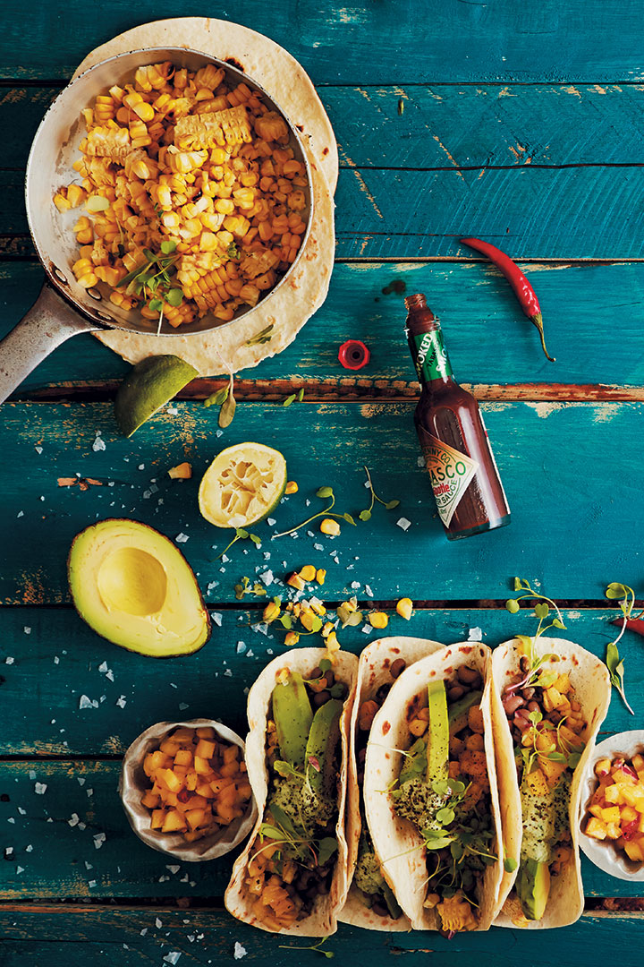 Flour soft-shell tacos with grilled corn, spiced black-eyed beans, cashew-nut cream and pineapple and chilli salsa