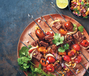 Steak kebabs with an onion, corn and sun-dried tomato salsa