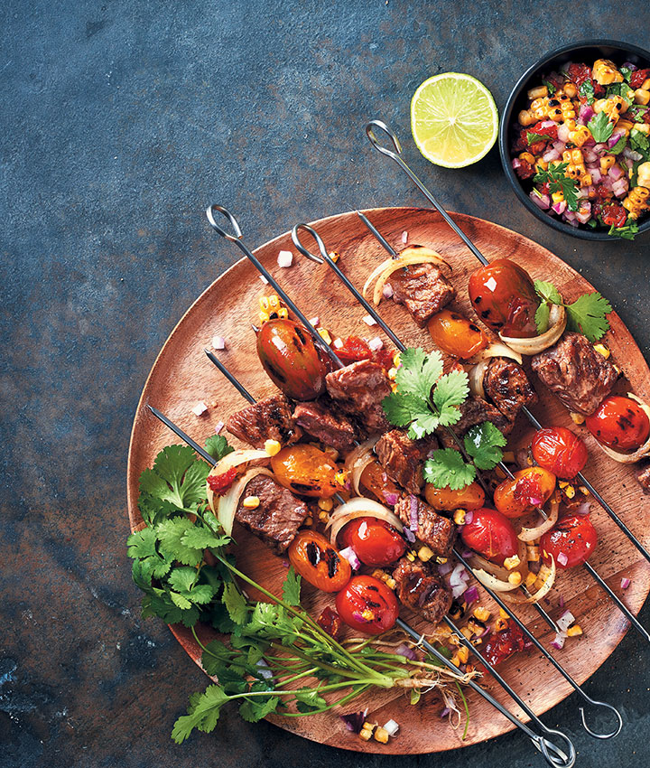 Steak kebabs with an onion, corn and sun-dried tomato salsa