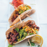 Tacos with vindaloo beans, crushed avocado and charred corn