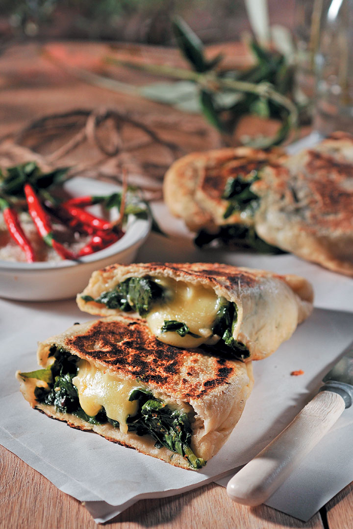 Calzone stuffed with spinach and smoked mozzarella