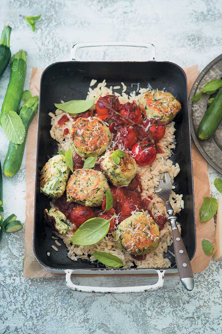 Cheesy baby marrow “meatballs" with orzo and spicy red wine sauce