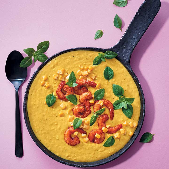 Sweetcorn, coconut and turmeric soup with paprika-fried prawns