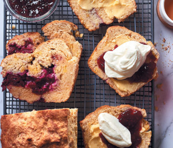 Cranberry scone loaf with butter, raspberry jam and whipped cream