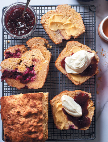 Cranberry scone loaf with butter, raspberry jam and whipped cream