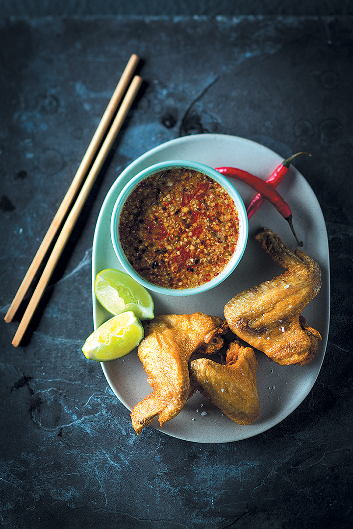 Crispy chicken wings with Cambodian tuk trey dipping sauce