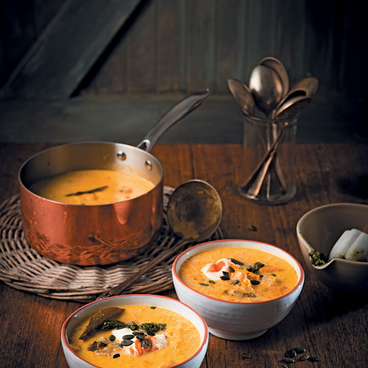 Smoky pumpkin chowder soup with pumpkin seed pesto and sriracha crème