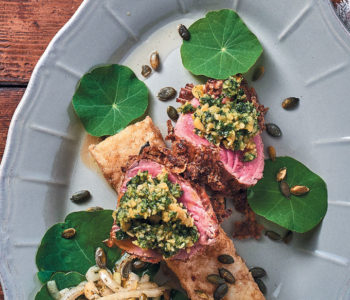 Beef fillet with biltong crust, nasturtium pesto, onion and pumpkin seed salad, and butter-fried maize (pap) squares