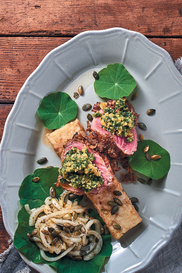 Beef fillet with biltong crust, nasturtium pesto, onion and pumpkin seed salad, and butter-fried maize (pap) squares