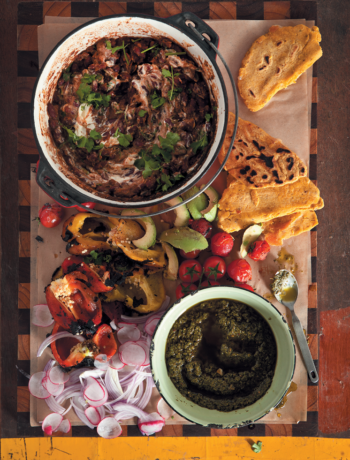 Barbecue pork shoulder with black beans, chimichurri and pupusas