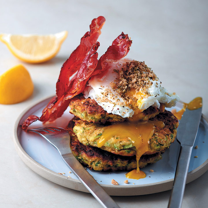 Dukkah-sprinkled poached eggs with zucchini fritters and crispy prosciutto