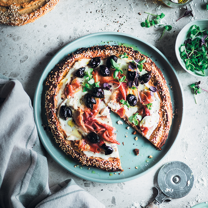 Sweet potato pizza with olives, ricotta and prosciutto