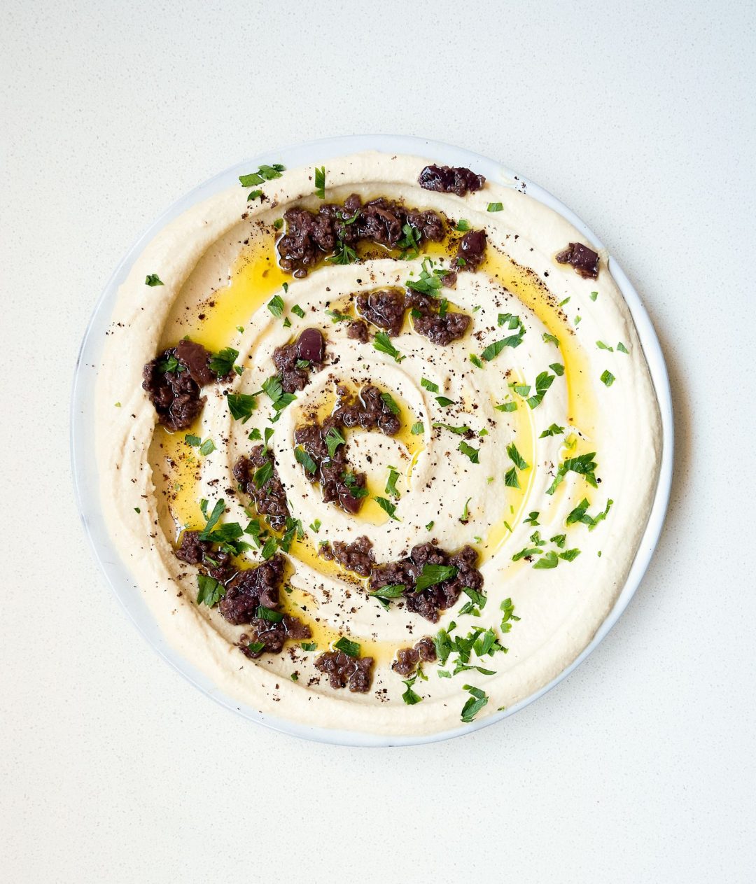 Hummus with olive pesto and sundried tomatoes