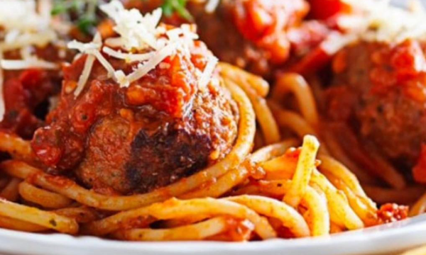 A mouth watering red spaghetti and meatballs toped with cheese by Booties Bar & Grill - Hillcrest Restaurants 
