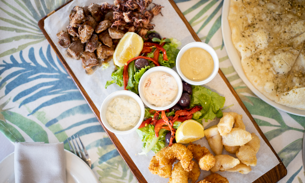 A platter of delicious menu items by Olive and Oil - Hillcrest Restaurants 